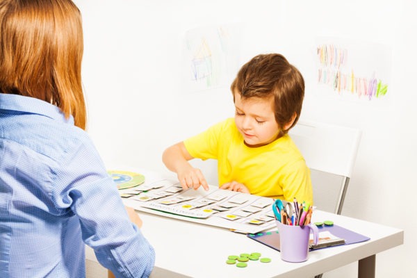 Boy plays in developing game pointing at calendar