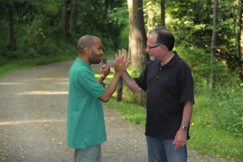 Tariq giving his dad, Dr. Robert Naseef, a high five