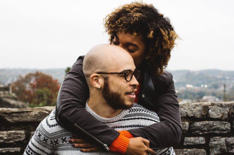 couple in front of a rock wall