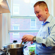 Transition Program student, Brian Hoyle, learning to cook in his own apartment (Photo courtesy of Lesley University)