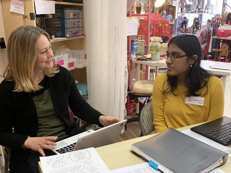 Baneesha discussing her blog post ideas with her coach, Laura