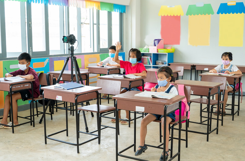 COVID-19 classroom with students social distancing and wearing masks