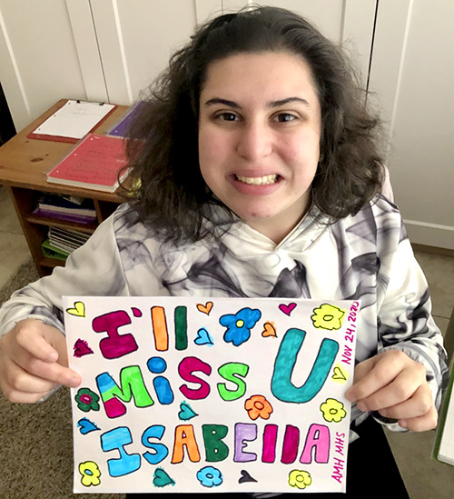 Amber Hinojo, who goes by her initials AMH, with a message for her Pace University mentor. She held up the sign their for final presentation.