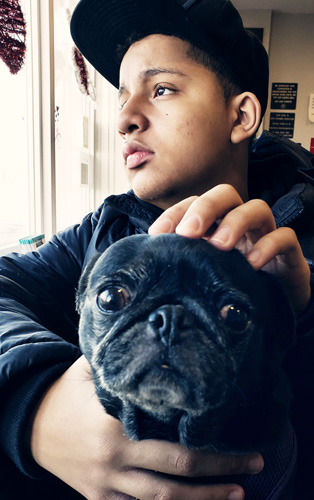 Lorenzo Watkins with his dog, Penny. Lorenzo says working on the Pace project has increased his confidence.