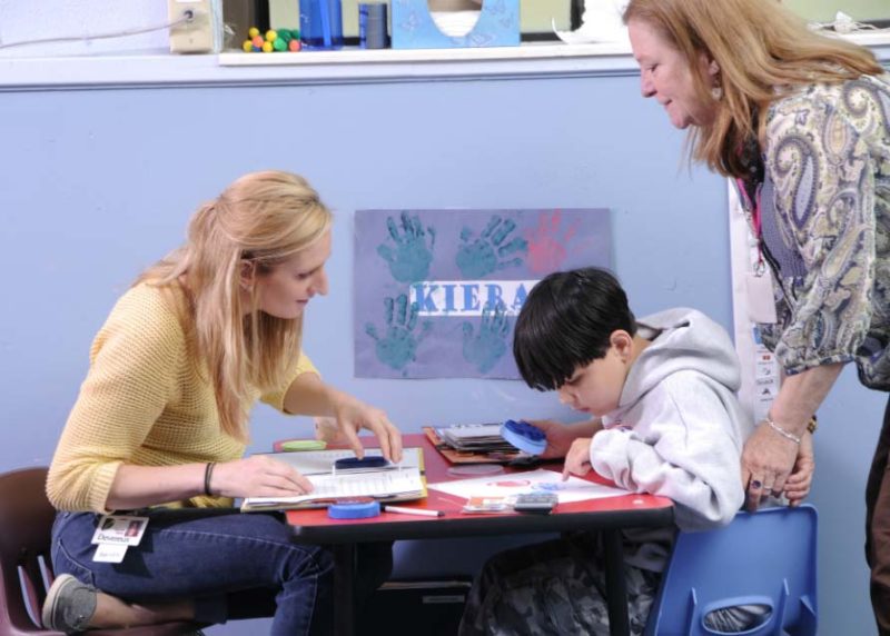 Child receiving instruction as part of PBIS Autism