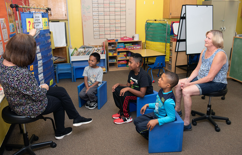 Peggy Yorkovich, teacher at First Children School, goes over the lesson plan of the day