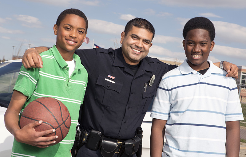 Policeman talking to kids in the community