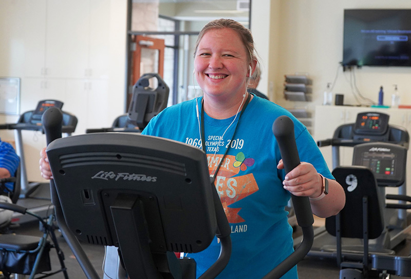 A resident of Marbridge in Manchaca, Texas enjoys a workout. Fitness centers are a key amenity for attracting prospective residents.