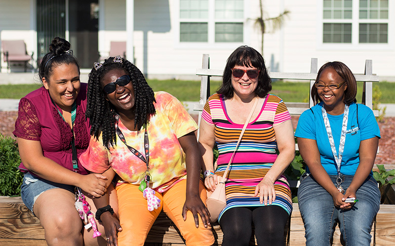 Residents of The Arc Jacksonville Village, one of various national properties listed in the Housing Market Guide, enjoying new friendships