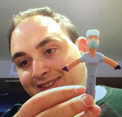 Tom Gambaro, of Brooklyn, with one of the hospital staff figurines he molded out of clay