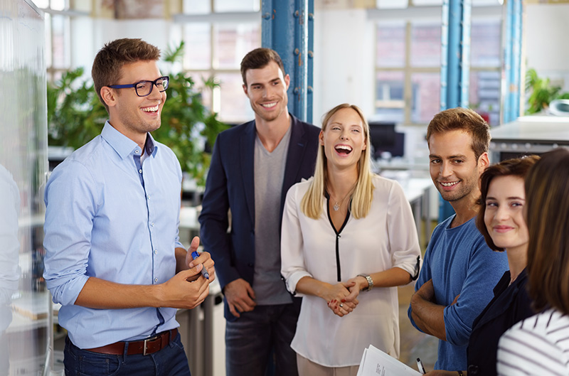 happy group of employees being social and laughing