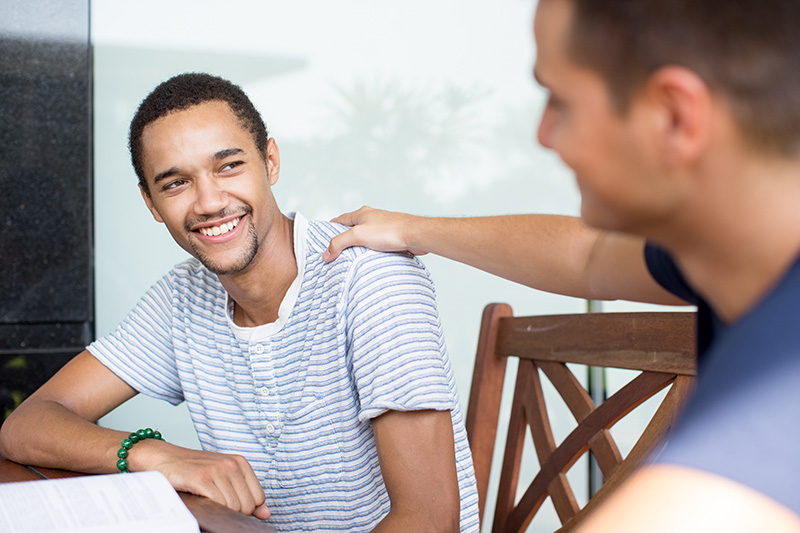 smiling young man receiving support