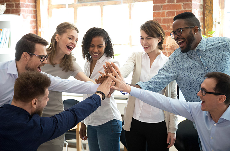 Happy diverse colleagues celebrate great teamwork