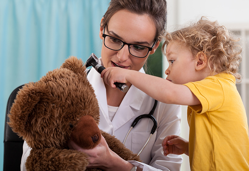 Boy with bear at pediatrician's office