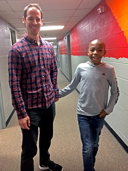 Dr. Bradley Stevenson and Simeon walk through the halls of Melmark Carolinas.