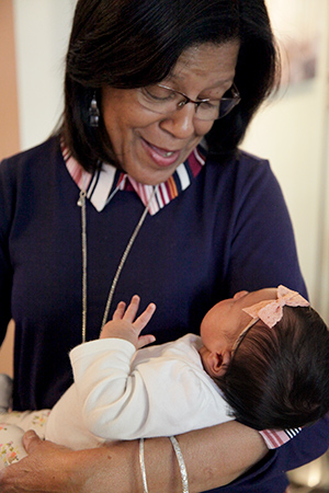 A grandmother holding her new granddaughter