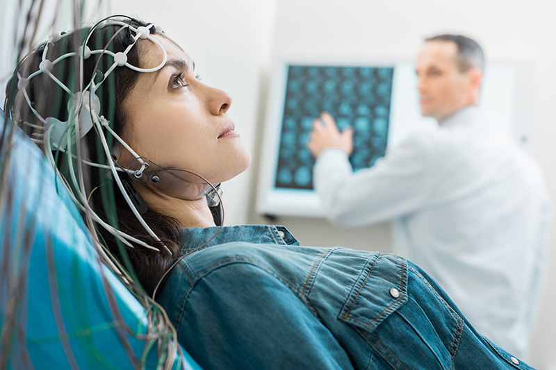Young woman undergoing electroencephalography (EEG)