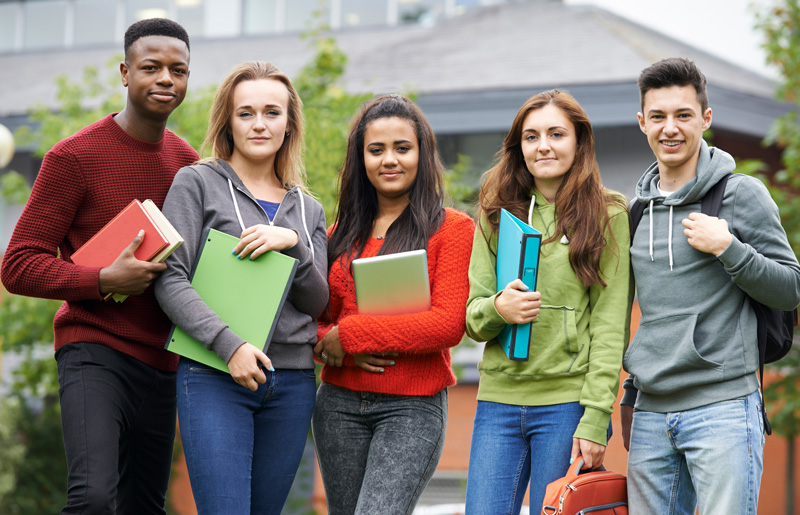 College students outside with their books