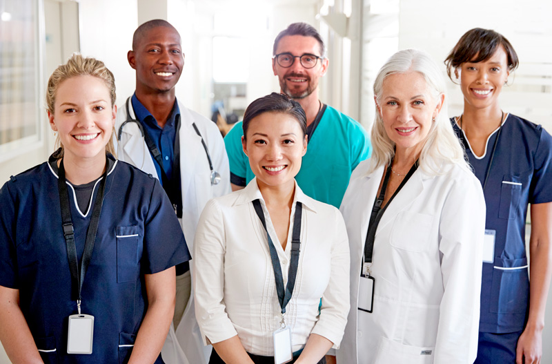 Portrait of a multidisciplinary team standing in a hospital corridor