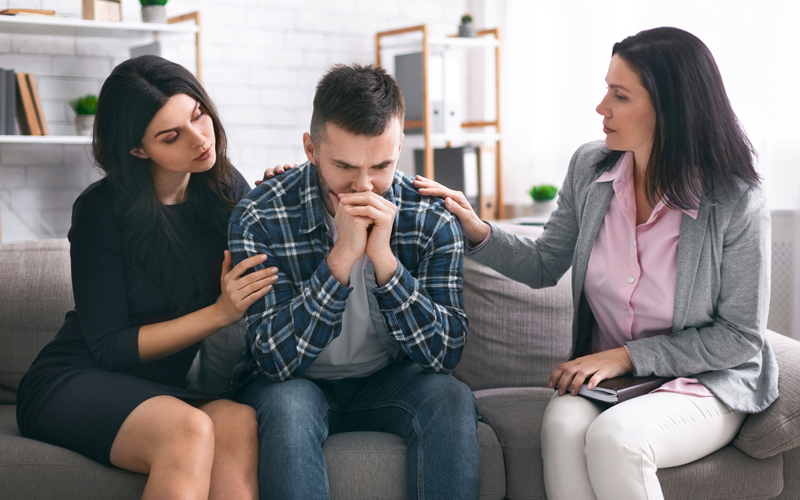 Depressed man feeling troubled at psychological therapy session