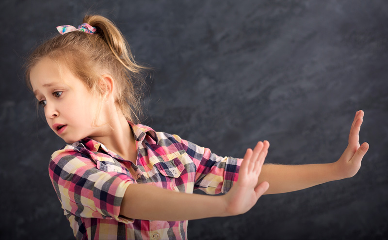 Young girl being non-compliant and saying no