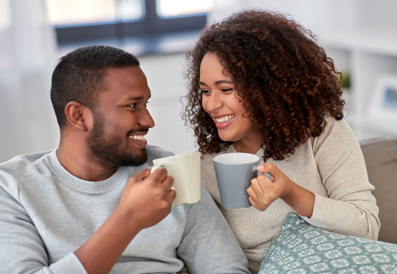 African American couple drinking coffee at home during breakfast